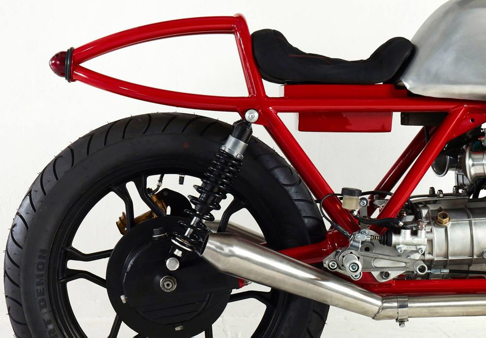Custom Moto Guzzi with red frame and polished alloy tank, side view