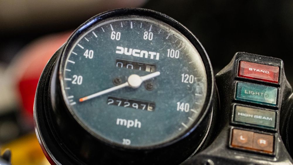 Classic Ducati speedometer in mph beside its warning lights