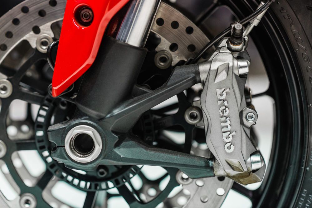 Brembo front brake caliper and disc on a red Ducati