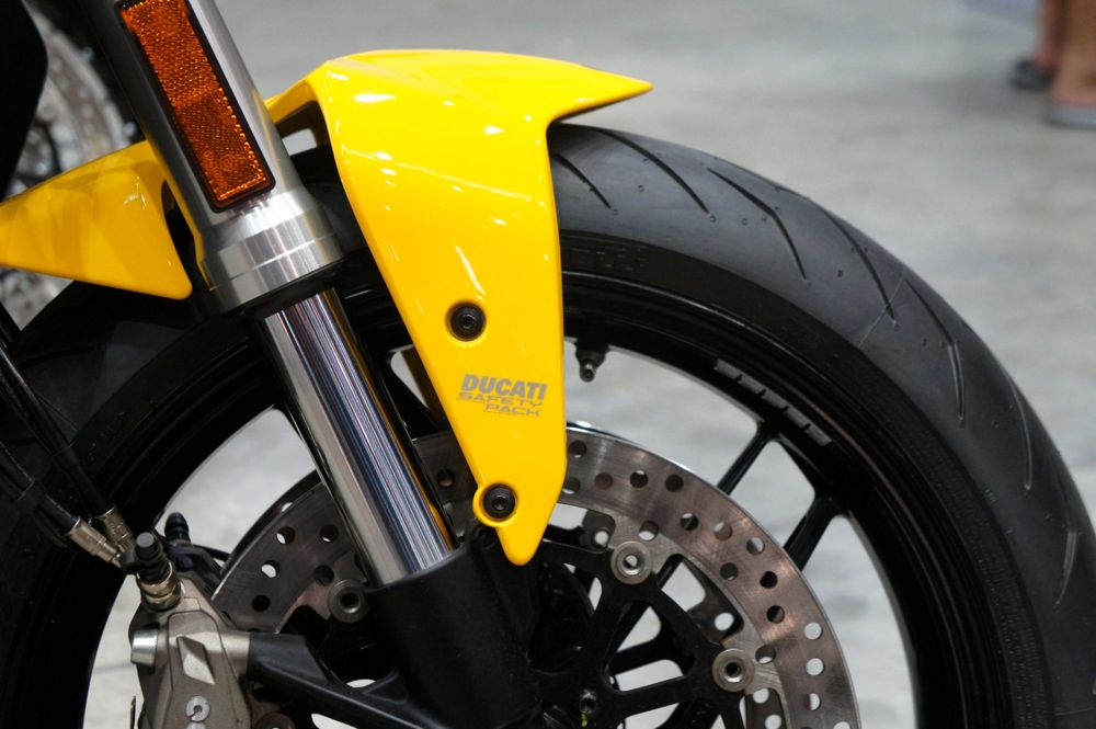 Front brake discs, fork and yellow mudguard on a Ducati