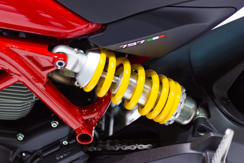 Yellow rear shock and red trellis frame of a Ducati Monster 797
