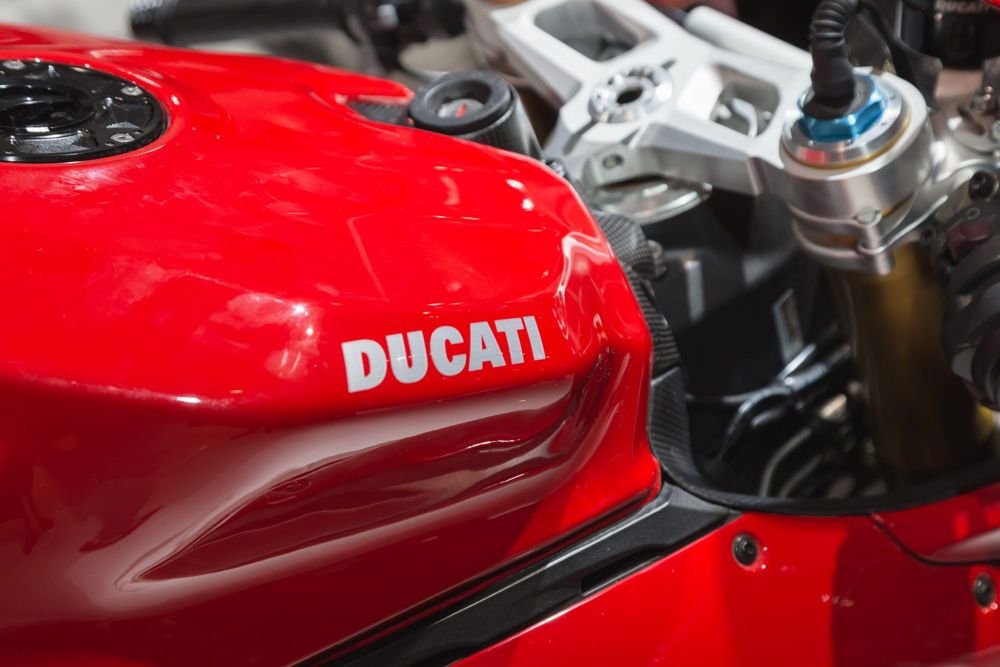 Red Ducati superbike tank beside the top yoke and fork