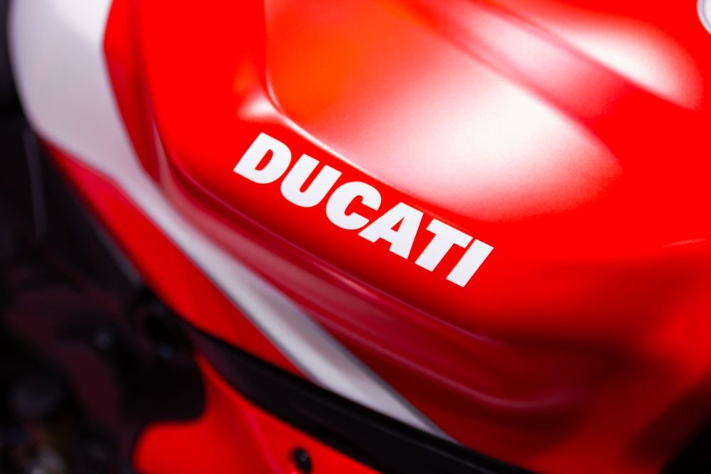 Ducati lettering on the red and white tank of a superbike