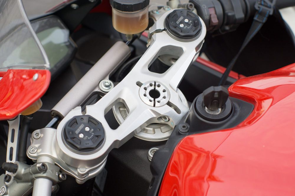 Billet top yoke and red tank of a Ducati superbike