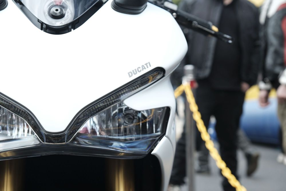 Headlights and front fairing of a white Ducati superbike