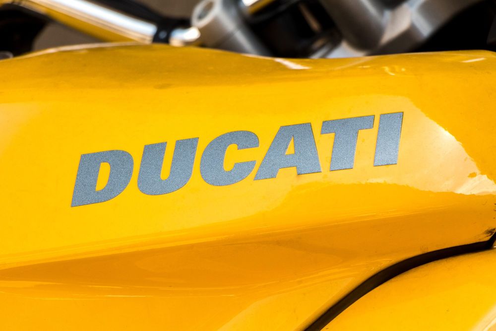 Grey Ducati lettering on yellow bodywork