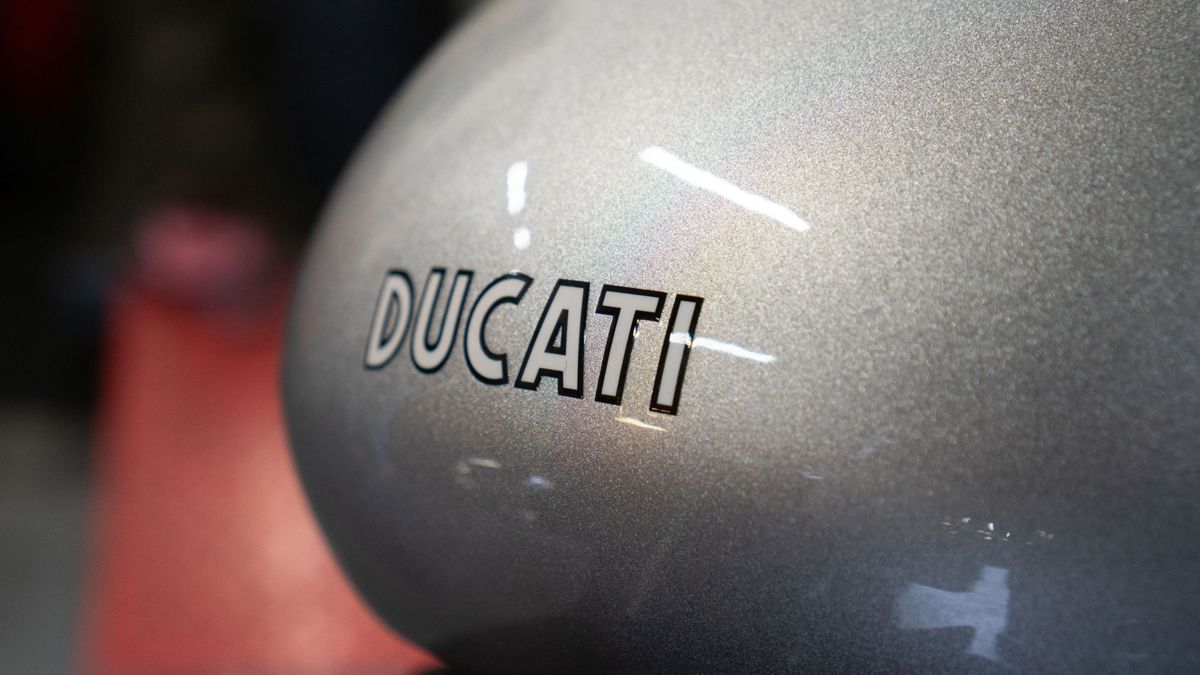 Ducati lettering on a silver fuel tank in the workshop