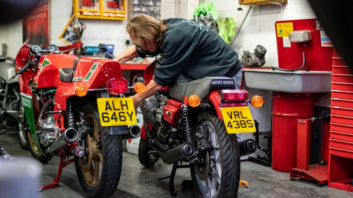 A classic Ducati and a Moto Guzzi being worked on side by side in the workshop