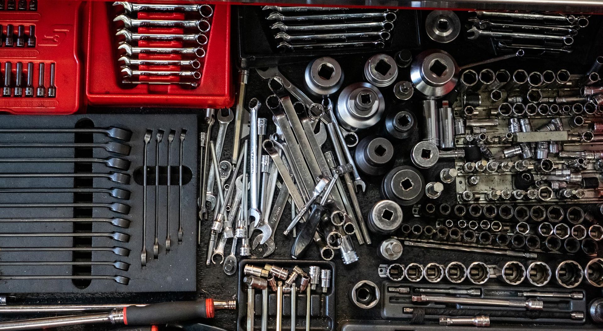 Spanners and sockets laid out in a tool drawer at Ray Petty Meccanica