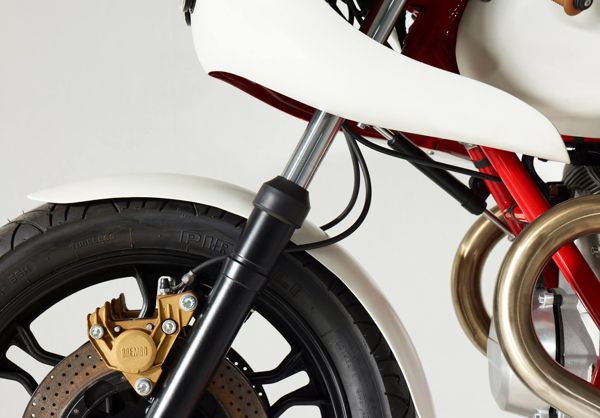 White fairing and gold Brembo caliper on the custom Moto Guzzi