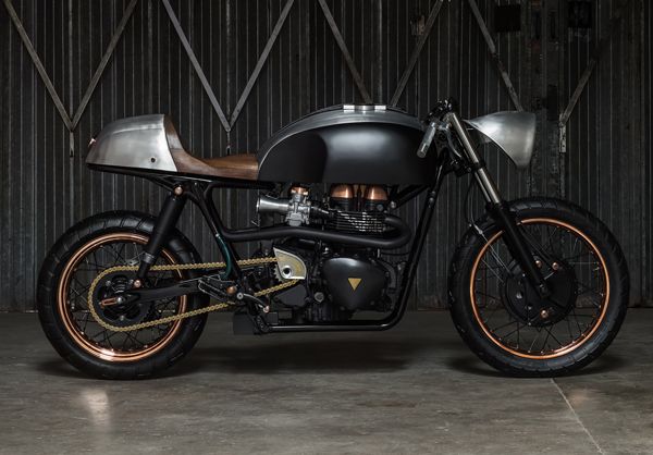 Up Yours Copper custom Triumph, right side view in a warehouse