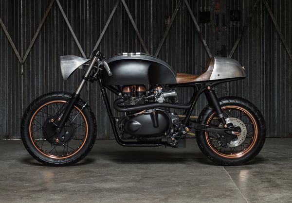 Up Yours Copper custom Triumph, side view in a warehouse