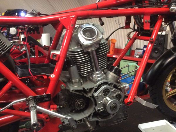 Air-cooled Ducati engine in a red trellis frame during a rebuild