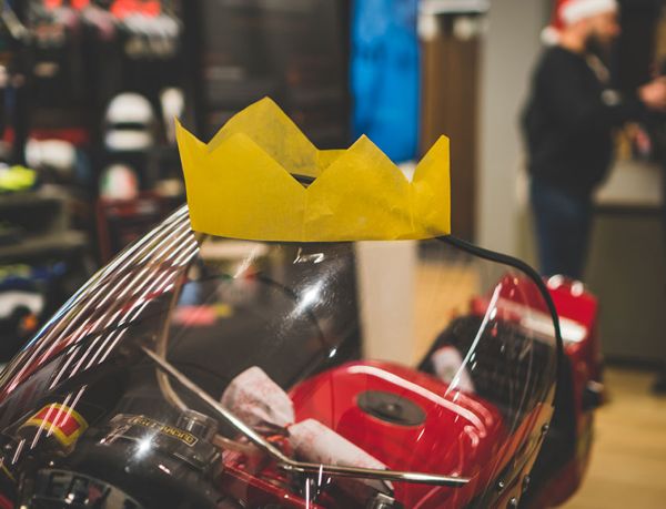 Red Ducati wearing a paper Christmas crown