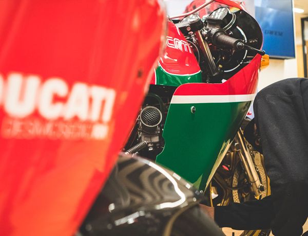 Desmosedici RR fairing in front of a classic red and green Ducati