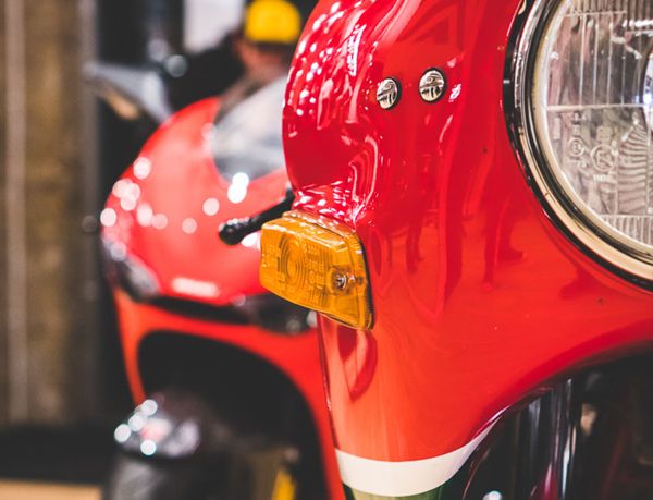 Red and green fairing and round headlight of a classic Ducati
