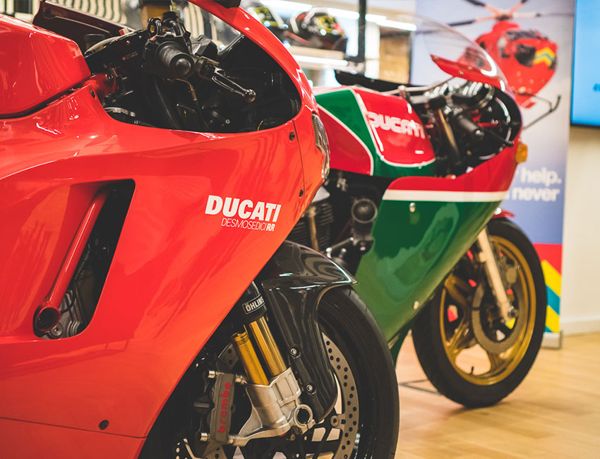 Desmosedici RR beside a classic Ducati in red, green and white