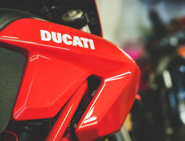 Ducati lettering on a red fairing in the workshop