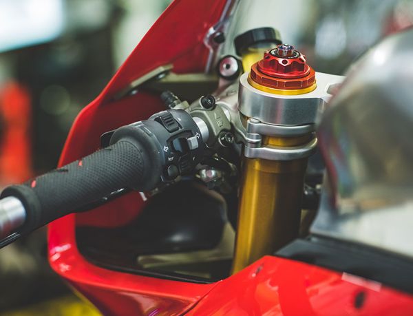 Handlebar and gold fork top on a red Ducati superbike