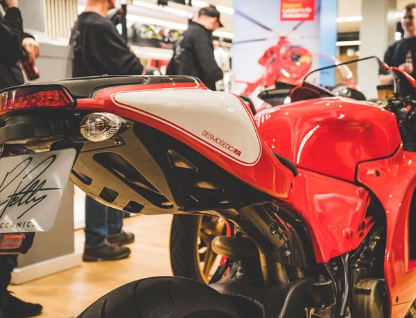 Desmosedici RR tail and exhaust, with visitors looking on behind