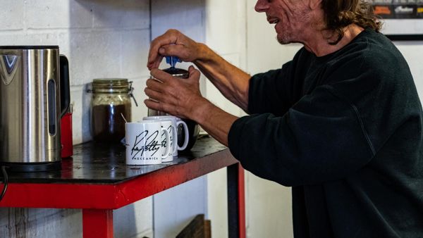 Mechanic making a drink in a Ray Petty Meccanica mug