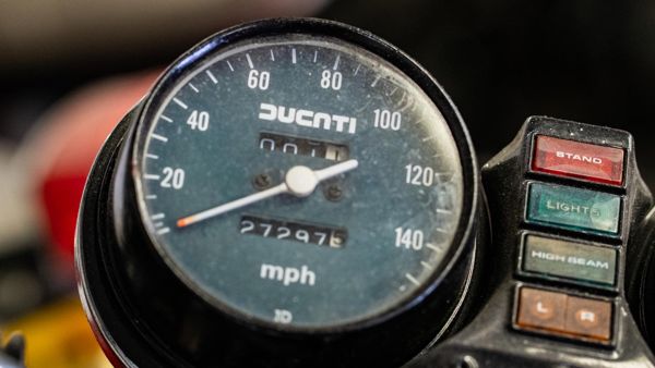 Classic Ducati speedometer in mph beside its warning lights