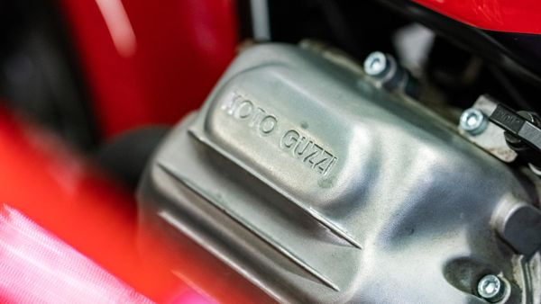 Moto Guzzi engine casing beside red bodywork