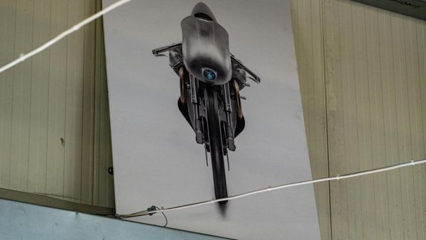 Photograph of a motorcycle hanging on the workshop wall