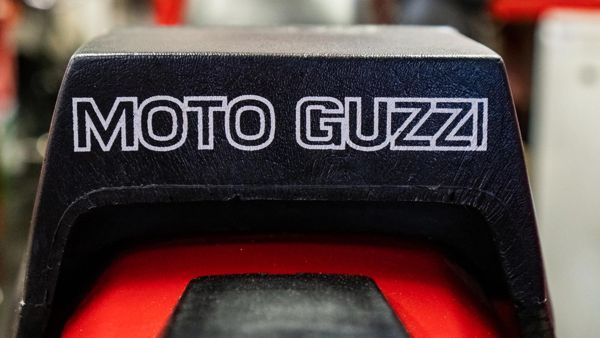 Moto Guzzi lettering on a black seat cowl