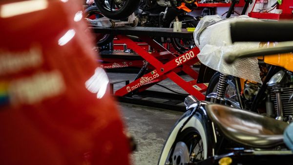 Classic Ducati on a red bench lift in the workshop