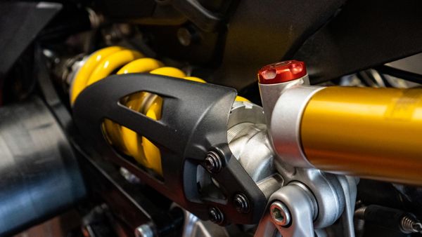 Gold rear shock absorber and yellow spring on a modern Ducati