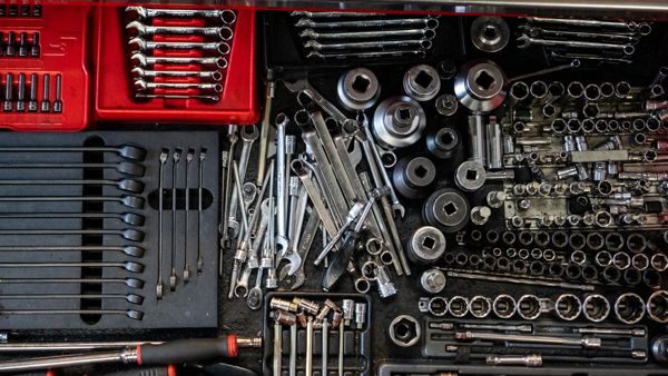 Spanners and sockets laid out in a tool drawer at Ray Petty Meccanica