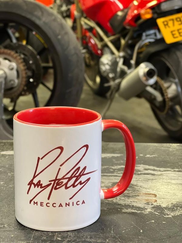 White mug with a red handle and the Ray Petty Meccanica logo in red