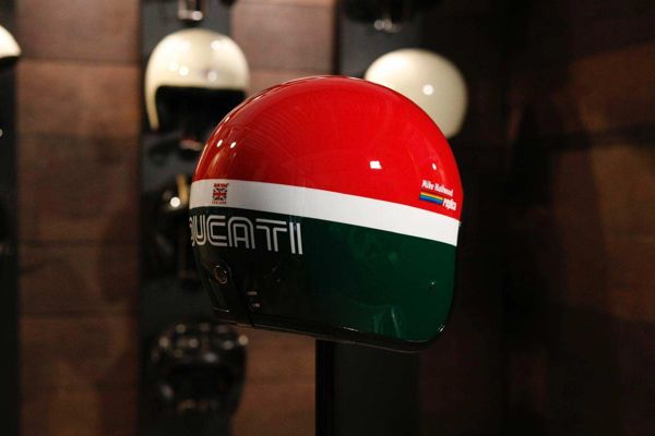 Red, white and green painted helmet on display in the workshop