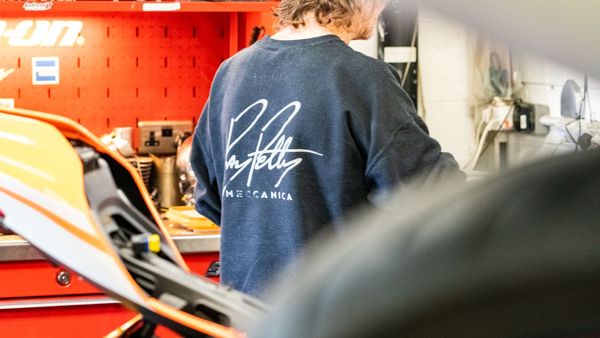 Working at the bench in a Ray Petty Meccanica sweatshirt