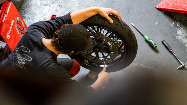 A rear wheel being worked on on the workshop floor