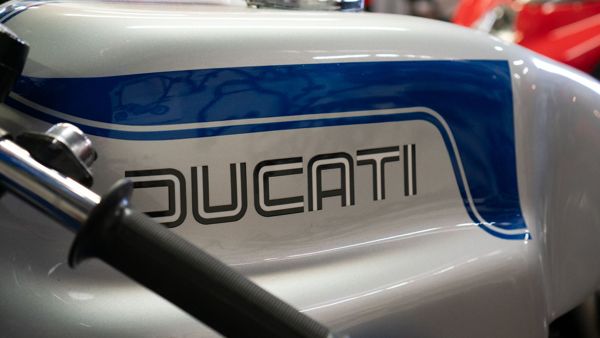 Ducati lettering on a silver and blue classic tank