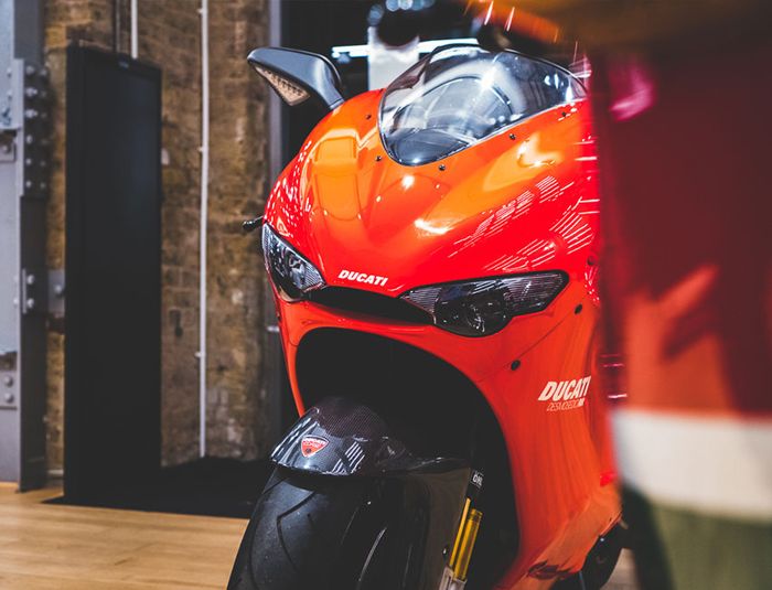 Red and white Ducati Desmosedici RR in the workshop