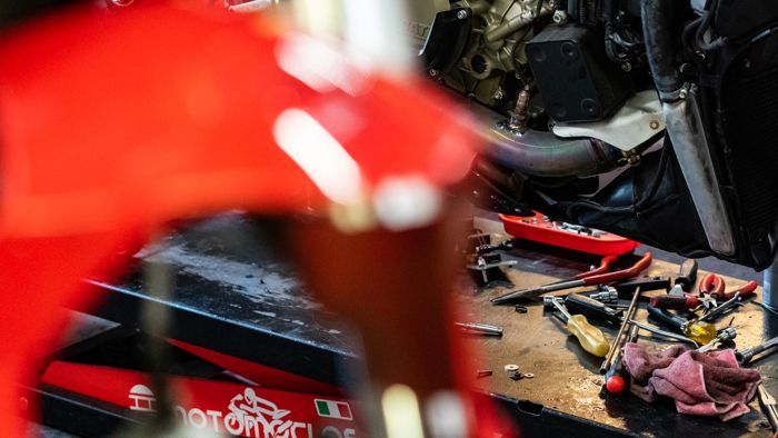 Red Ducati fairing and tools on the bench in the RPM workshop