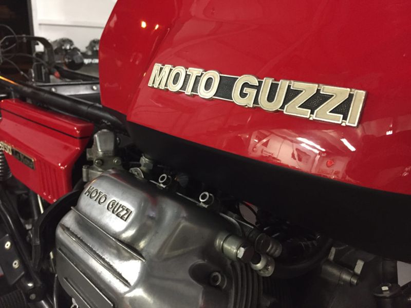 Moto Guzzi badge on a red tank above the polished engine