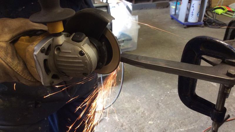 Sparks from an angle grinder as a part is shaped in the workshop